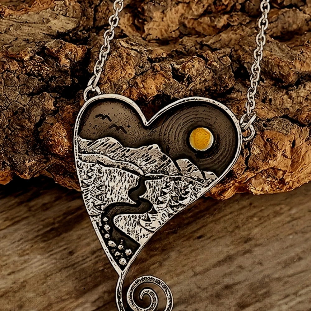 Silver Heart Shaped Necklace with Mountain Design